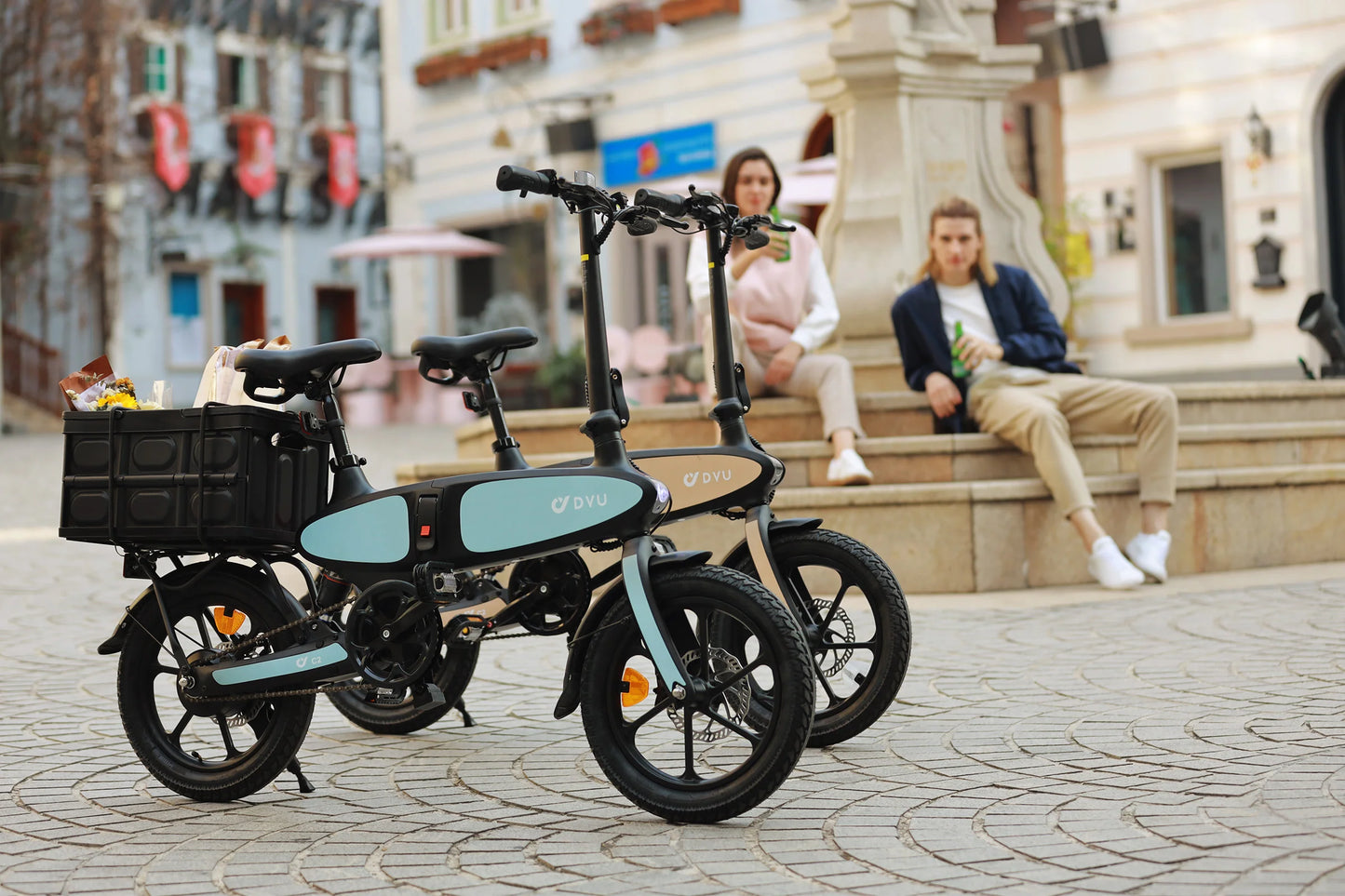 DYU C2 16 Inch Full Folding Electric Bike with 250W Mottor 500W Peak 48V7.5AH Battery black and blue models parked on cobblestone street